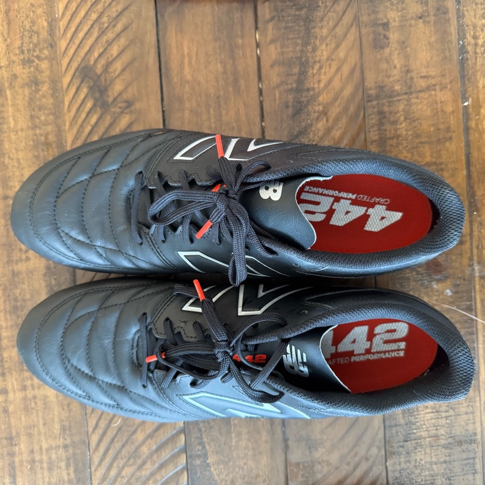 Like new New Balance Men’s Black Athletic Shoes with Red Accents